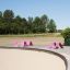 Pink Lounge Chairs on a Wooden Deck by a Sandy Beach