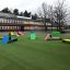 Colorful Lounge chairs placed on a grassy schoolyard.
