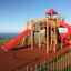Outdoor wooden playground with red slides and climbing structures.
