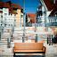 Kyoto Sofa outdoor wooden bench in an urban setting.
