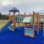 Square Play castle with slide on a playground.