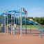 Children playing on Sirius steel structure playground equipment in a park.