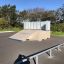 Skate ramp Rail 25/60 in a park with trees in the background.