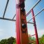Outdoor fitness equipment New Age Fit MEDIUM with red and orange tall structure.