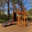New Age Fit MEDIUM outdoor fitness station with climbing and exercise equipment in a forest setting
