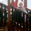 Child playing on Apollo castle with slide, wooden playground structure
