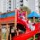 Children playing on Space Station castle with slide in a playground