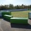 Multiarena, outdoor playing field with green benches and goals.