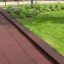 Rubber Tiles 55 installed as safety flooring bordering a garden area.