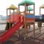 Playground structure with red slide and Rubber Tiles 75 flooring.