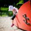 a child playing in the ship sandpit