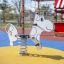 Cow rocking play equipment on playground.