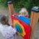 Children playing with Clock playground panel.