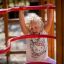 Child playing on Activity Center wooden playhouse.