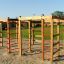 Wooden Activity Center playhouse with climbing structures on a playground.