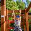 Child playing on Activity Center wooden playhouse