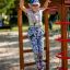 Child playing on the Activity Center wooden playhouse in a sunny playground.