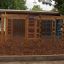 Activity Center wooden playhouse with rope ladders and climbing nets in a playground area