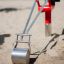 Metallic Excavator toy on a sandy playground.