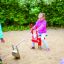 a girl playing on the sand excavator on the playground in the kindergarten