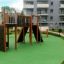 Children's playground set 'Spiderman' with various climbing and sliding features in a residential ar