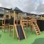 Outdoor Explorer castle with slide in a playground.