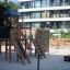 Explorer wooden playground set with slides and climbing wall in urban outdoor area