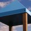 Blue rooftop of Logo Tower with Firepole playhouse with slide against a cloudy sky.