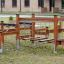 Outdoor wooden Obstacle Course playground equipment with suspended bridges and climbing ropes.