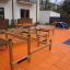 Children's playground climbing structure Course with wooden frames and rope nets on an orange surfac