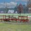 Obstacle Course playground equipment made of wood and metal installed outdoors on grassy area.