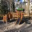 Smart Modern Nature wooden playhouse with slide in a playground setting