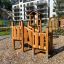 Smart Modern Nature wooden playhouse with slide in front of residential buildings