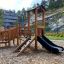 Smart Modern Nature wooden playhouse with slide in outdoor setting