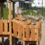 Rubik Modern Nature wooden playhouse with slide in a community park.