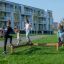 Children and adults playing on the Balance outdoor playground equipment.