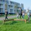 Children playing on the Balance outdoor playground equipment in a residential area.