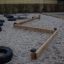Balance course made of wooden beams and tires in a playground.