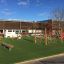Children's playground equipment named Balance on an outdoor grassy area.