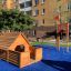 Wooden Veranda House Nature playhouse in a playground.