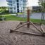 Wooden Atakama playground climbing structure in a residential area.