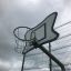 Basketball hoop with a unique backboard design on outdoor court, part of the Basket Organic product 