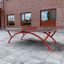 Outdoor Table Tennis set up in a school courtyard with red metal legs and a net.