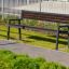 Outdoor Oxford Bench in a grassy area by a pathway