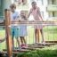 Children playing on a Chain Bridge playground equipment.