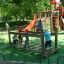 Children playing on the Chain Bridge playground equipment with slides in the background.