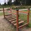 Wooden play equipment Chain Bridge in a park setting.