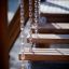 Wooden Chain Bridge playground equipment with hanging chains.