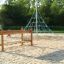 Chain Bridge children's playground equipment with ropes and wooden structures on a sandy surface