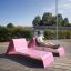 Person relaxing on a pink Lounge Sofa outdoors